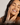 A lady touching her cheeks and smiling